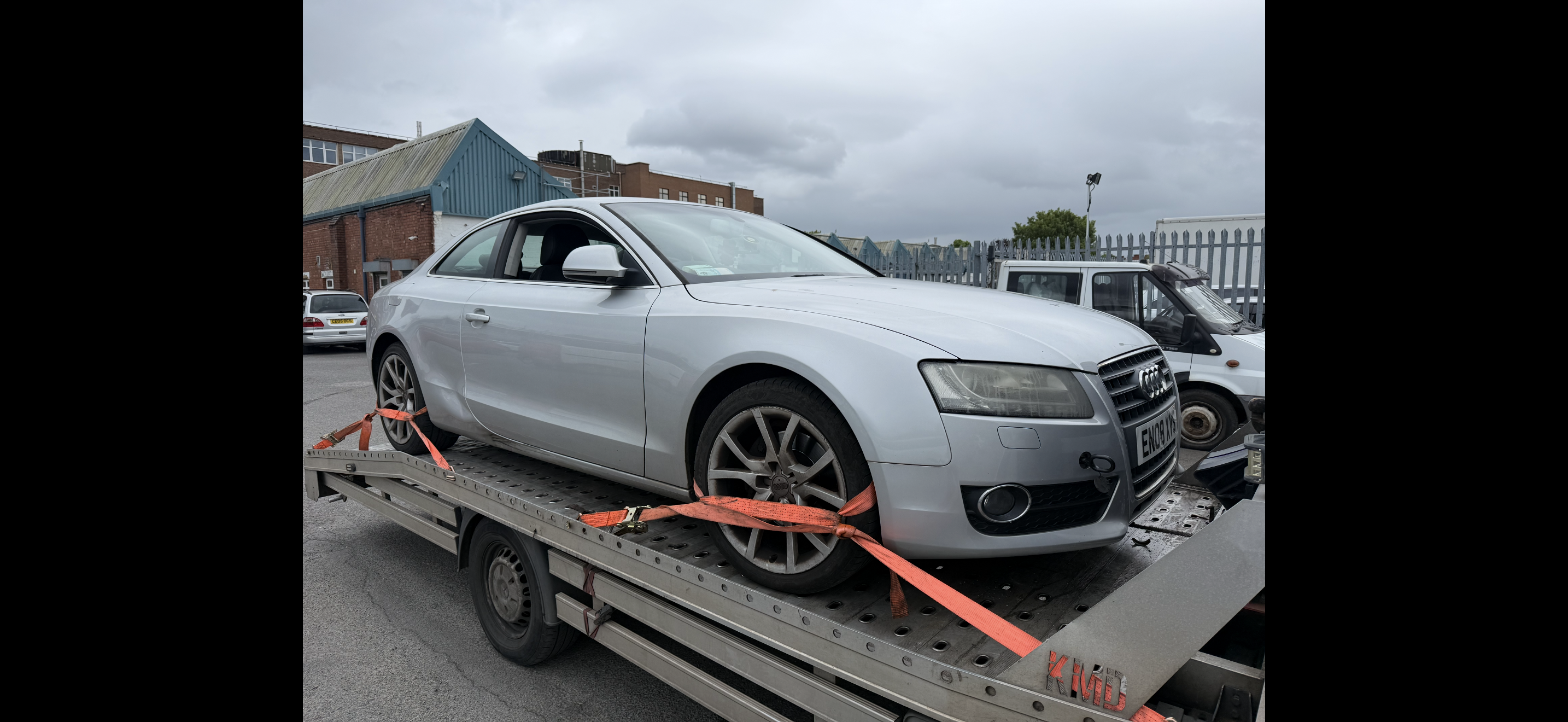 Silver Audi secured on recovery truck for removal from private land – Coventry